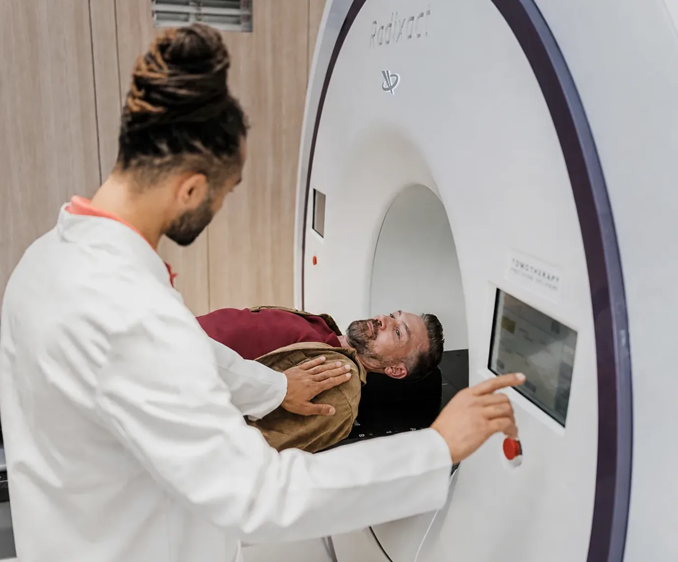 Patient completing a scan with a medical imaging technologist